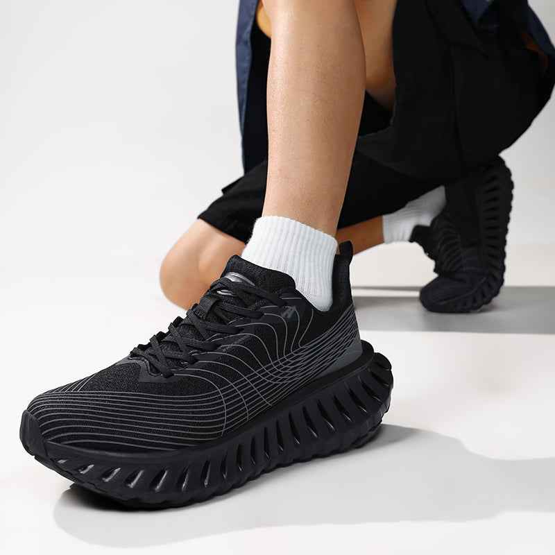 Swag Chic black sneakers with unique sole design worn with white socks on a model