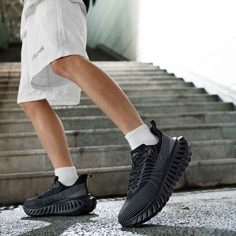 Swag+Chic black sneakers worn with white crew socks and white shorts on concrete stairs
