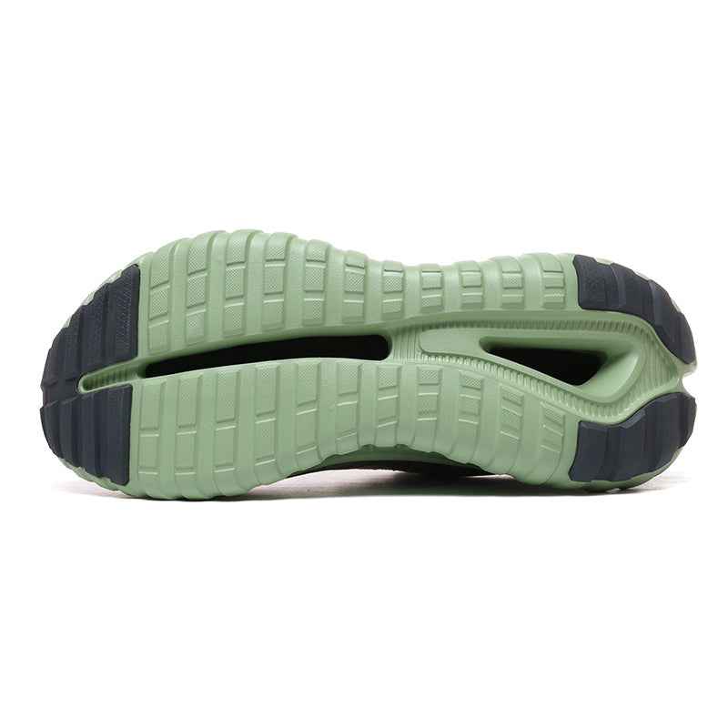 Bottom view of green and black Swag Chic sneakers sole with detailed tread pattern